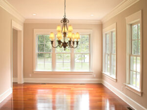 Beautiful dining room with a chandelier and wood double-hung windows.